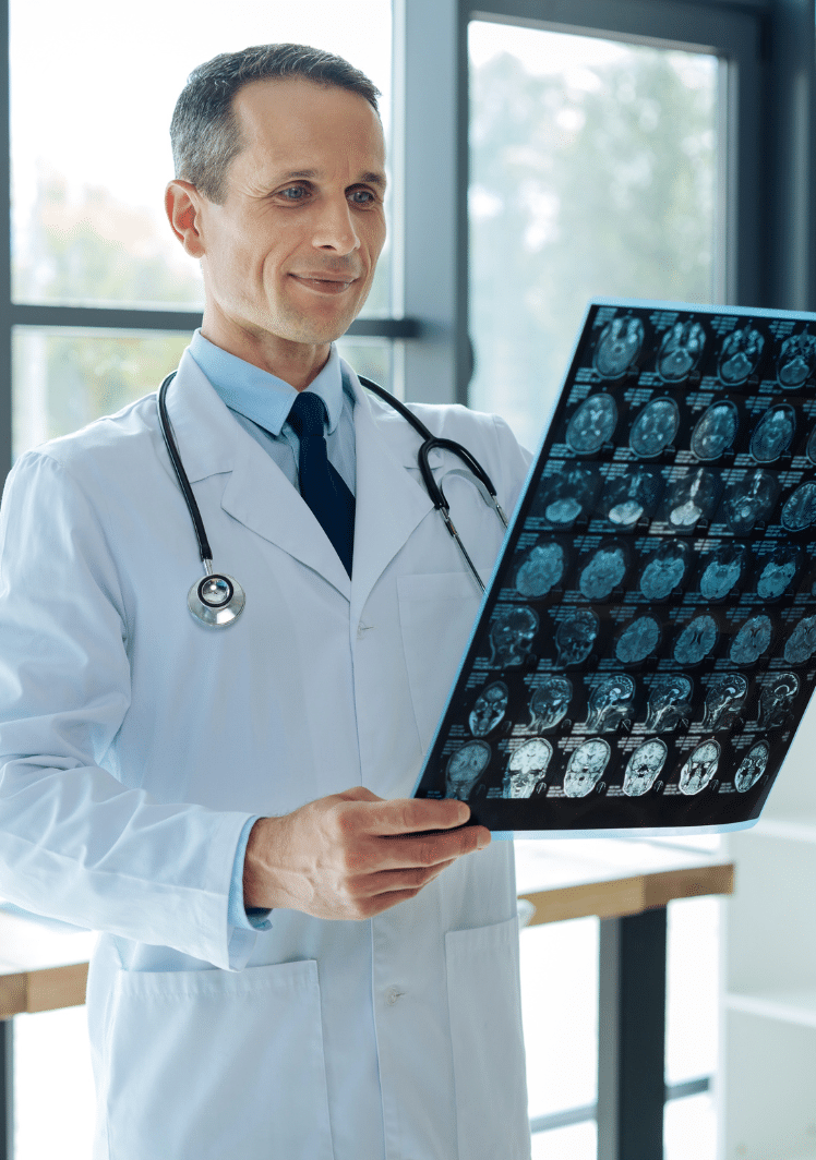 neurologist looking at a brain scan film